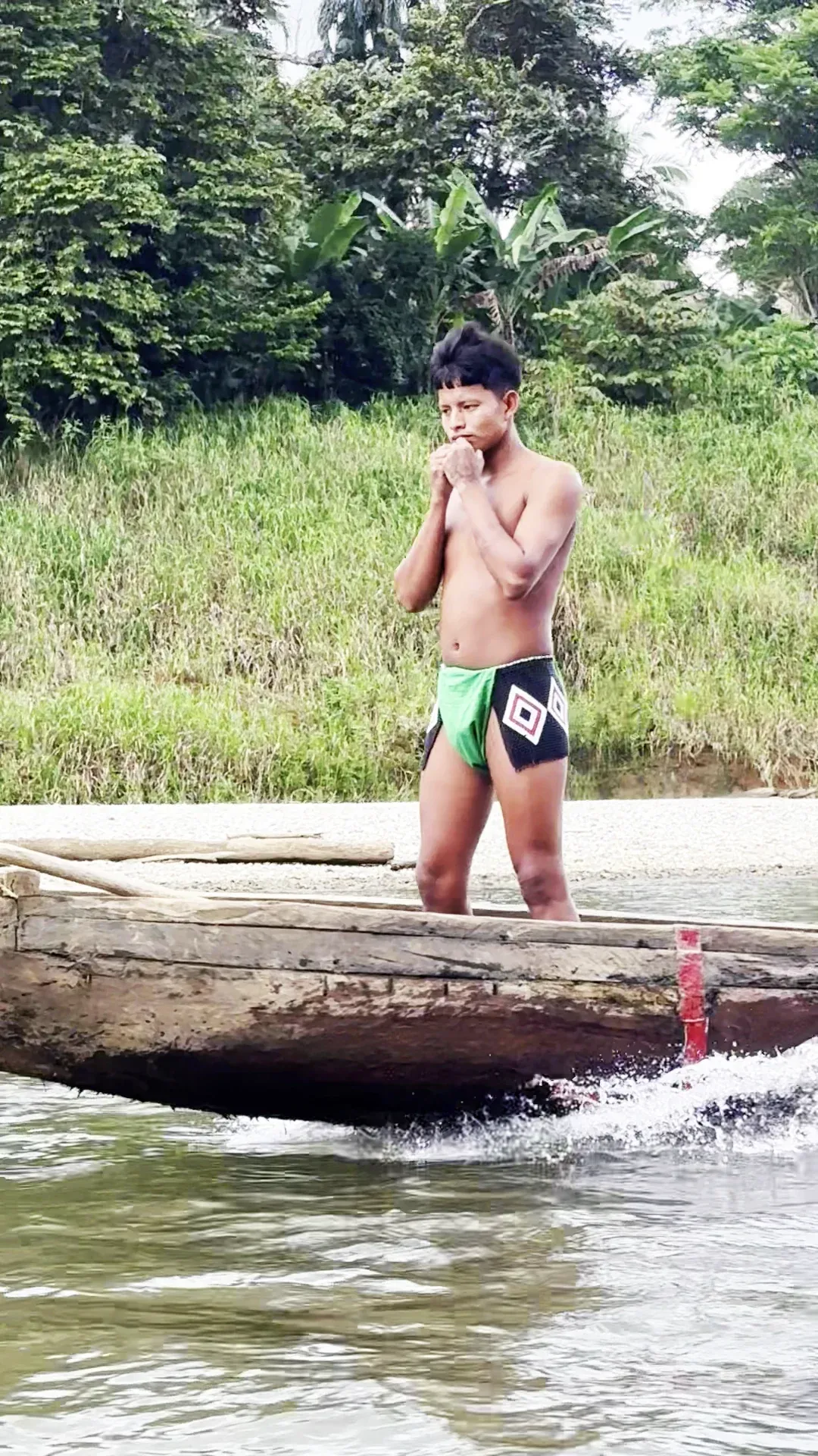 embera boy on a piragua boat